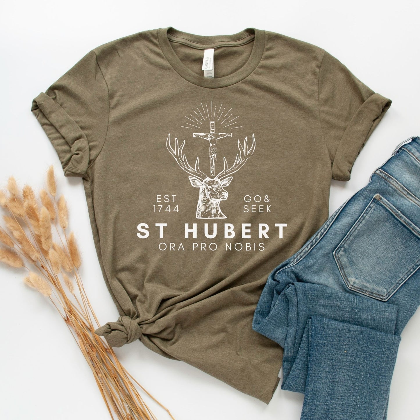 a t - shirt that says st hubert on it next to a pair of